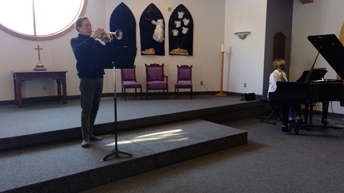 Trumpeter and Pianist preparing Christmas music