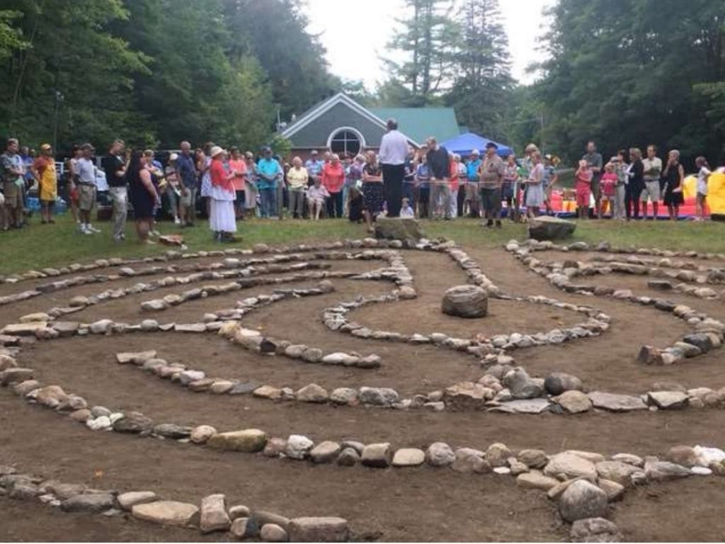 Group of people looking at a stone labyrinth